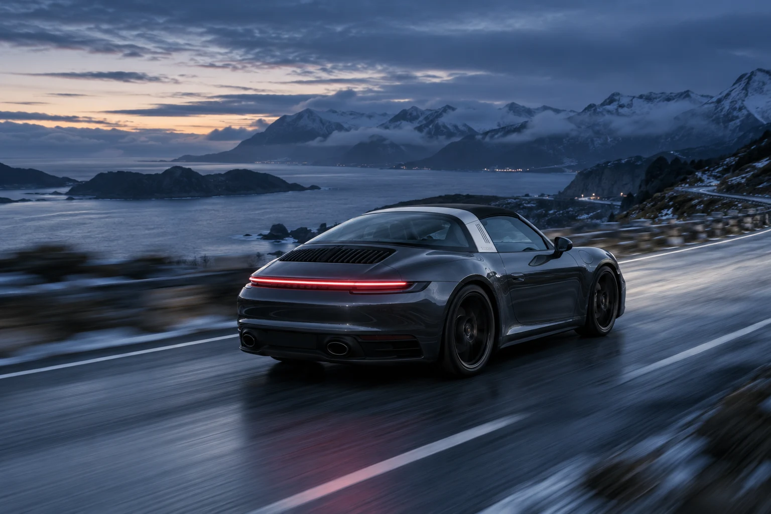 A sports car in motion on an atmospheric coastal road